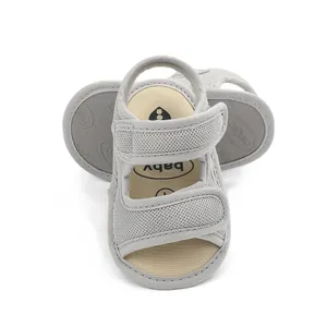 Detail showing gray breathable mesh baby sandals with double hook and loop straps.
