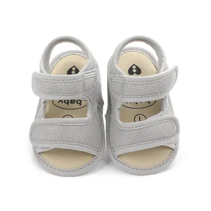 Close-up overhead view of breathable gray mesh baby walker sandals with dual velcro straps