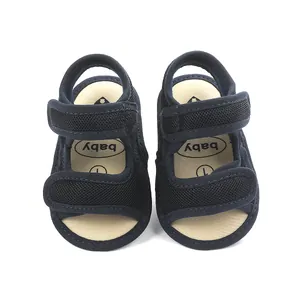 Close-up of navy blue baby sandals with breathable mesh and adjustable straps