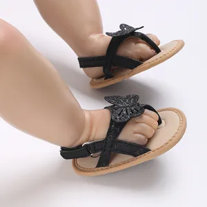 Detail view of black baby summer walking sandals with butterfly applique and soft sole