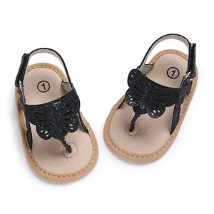 Detailed view of baby summer sandals with black glitter butterfly design and soft sole