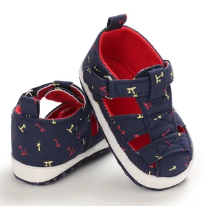 Close-up of baby canvas sandals with palm tree pattern and soft white sole.