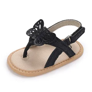 Close-up of black baby thong sandal with decorative butterfly detail and soft sole.
