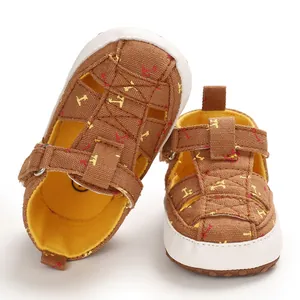 Detailed view of infant brown cotton sandals featuring yellow patterned soft soles