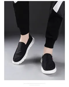 Close-up of black slip-on shoes for men featuring thick white EVA foam soles