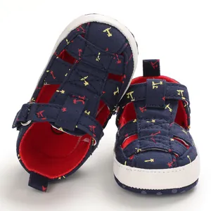 Detailed macro view of navy blue infant canvas sandals with soft white anti-slip soles