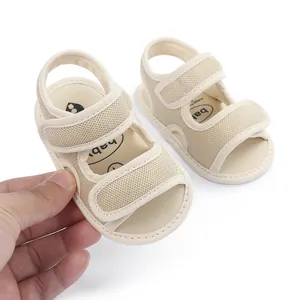 Detail showing breathable mesh fabric and velcro straps on beige baby sandals