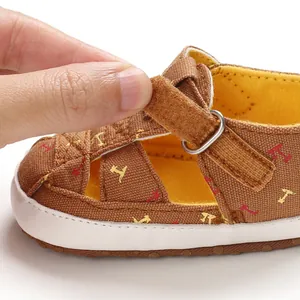 Close-up of brown infant walker sandal showing soft canvas texture and velcro strap