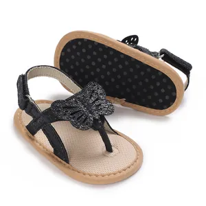 Detail view of infant sandals with a sparkly butterfly and anti-slip polka dot sole
