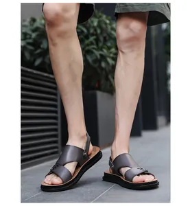 Side view of men's casual outdoor leather sandals worn on feet in an urban setting