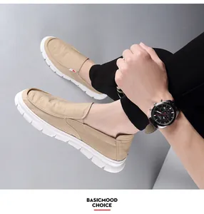 On-foot view of men's casual beige canvas loafers featuring a soft white breathable sole