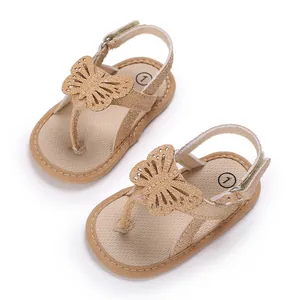 Detailed view of gold glittery baby walking sandals with butterfly decor and soft sole
