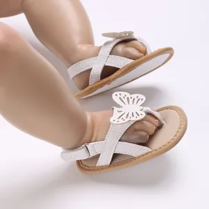 Close-up of white baby walker sandals with butterfly cutout and soft breathable sole.