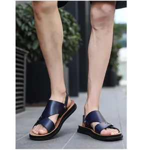 Close-up of men's navy blue casual sandals worn outdoors for summer beach fashion.