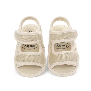 Detailed view of breathable beige mesh baby sandals with dual velcro straps for summer.