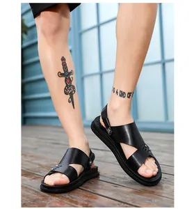 Detailed view of stylish black leather men's sandals worn by a model on a wood deck