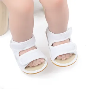 Detail view of breathable white mesh baby sandals with secure adjustable velcro straps
