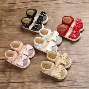Five pairs of soft-sole baby princess walking shoes with bow details on wooden floor