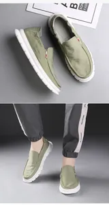 Detailed views of casual men's green slip-on shoes with comfortable soft white soles.