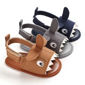 Three pairs of shark-themed soft sole baby walking sandals in brown grey and navy blue