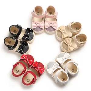 Variety of colorful baby girl bow soft-sole toddler princess shoes in a circle