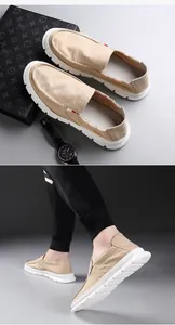 Men's khaki loafers shown in a lifestyle set with a watch and worn by a model in detail.