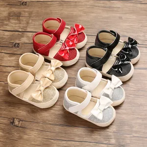 Detail of baby princess walking shoes with glitter finish and decorative bows in four colors