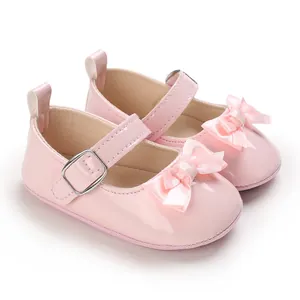 Soft sole pink baby girl walking shoes with decorative bow accent and buckle strap
