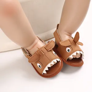 Close-up of cute brown cartoon shark baby sandals with soft breathable soles