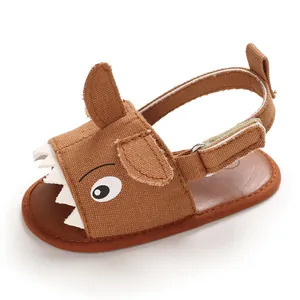 Side view of brown cartoon shark baby sandal with soft sole and velcro strap