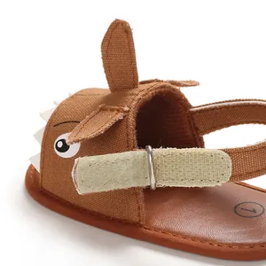 Close-up of brown canvas baby walker sandal with cute cartoon animal design detail