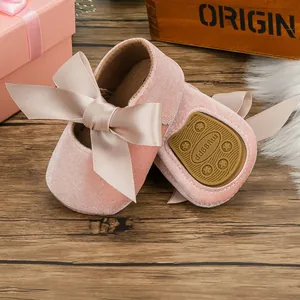 Close-up detail of pink velvet baby princess shoes with soft non-slip star patterned soles