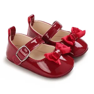 Detailed view of red patent leather baby Mary Jane walker shoes with bow decoration