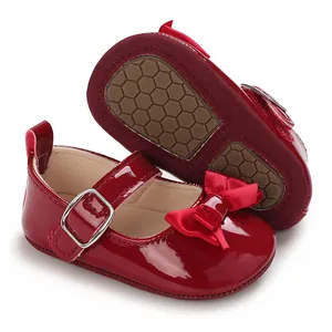Red patent leather baby girl walking shoes with soft non-slip sole and bow detail