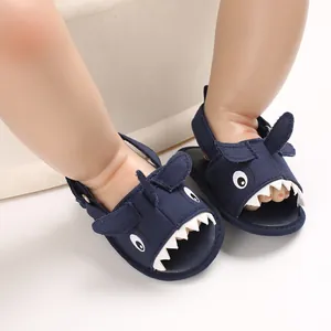 Detailed close-up of breathable navy blue canvas baby sandals with a fun shark motif