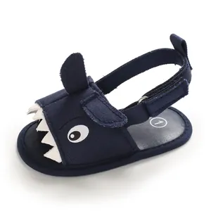 Detailed macro view of navy blue shark-themed baby sandals with soft soles for summer.