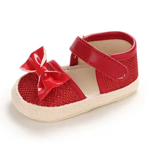 Detailed side view of a red baby walker shoe with a decorative bow and glitter finish