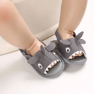Close-up of grey shark-themed baby sandals with soft soles and adjustable straps