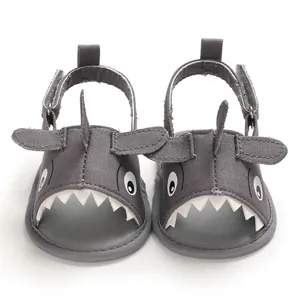 Close-up view of grey cartoon shark baby sandals with soft breathable soles for summer toddler use