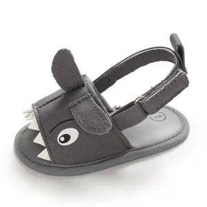 Close-up of gray shark baby sandal with soft sole and hook-and-loop strap