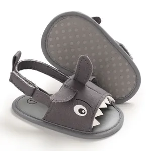 Close-up of grey cartoon shark baby sandals showing soft anti-slip dotted sole texture