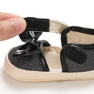 Close-up of hook-and-loop strap on baby soft-sole princess walking shoes.