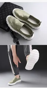 Detailansicht grüner Slipper mit strukturierter weißer Sohle für Herren im Freizeitlook.