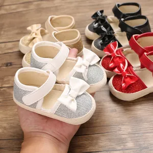 Close-up of sparkly glitter baby princess walking shoes with adorable bow detail