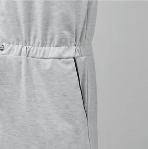 Close-up of drawstring waist and black piped pocket on men's gray jumpsuit