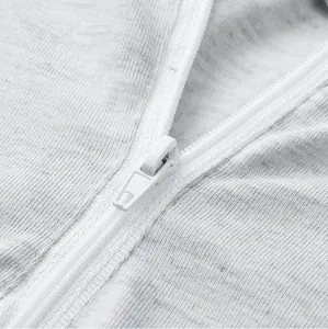 Detailed macro view of high-quality white nylon zipper on light grey heathered jersey fabric