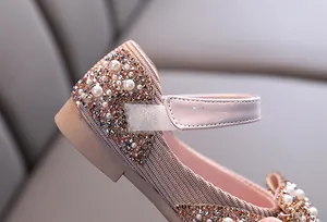 Detail of pink girls' dance shoe with sparkling rhinestones and pearls