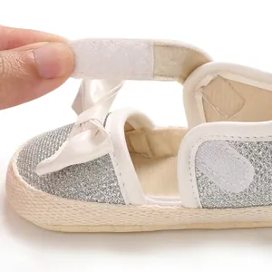 Detail view of white velcro fastener on silver glittery soft sole baby princess shoes