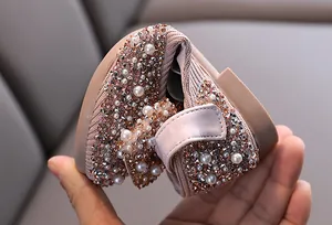Close-up of flexible soft sole on girls' rhinestone and pearl performance dance shoes