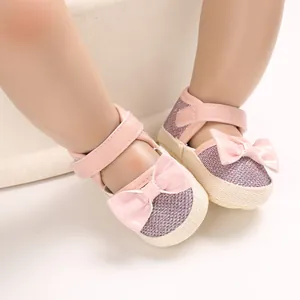 Pink soft sole baby walker shoes with glitter finish and decorative bow detail